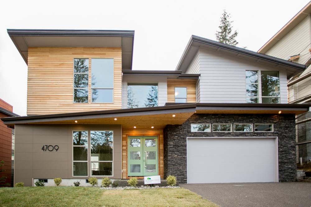 A two-story home with varying siding materials. The bottom right features Nichiha Architectural Block fiber cement siding in Mocha.